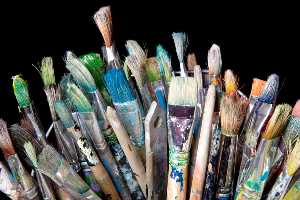 many used brushes for painting and black background